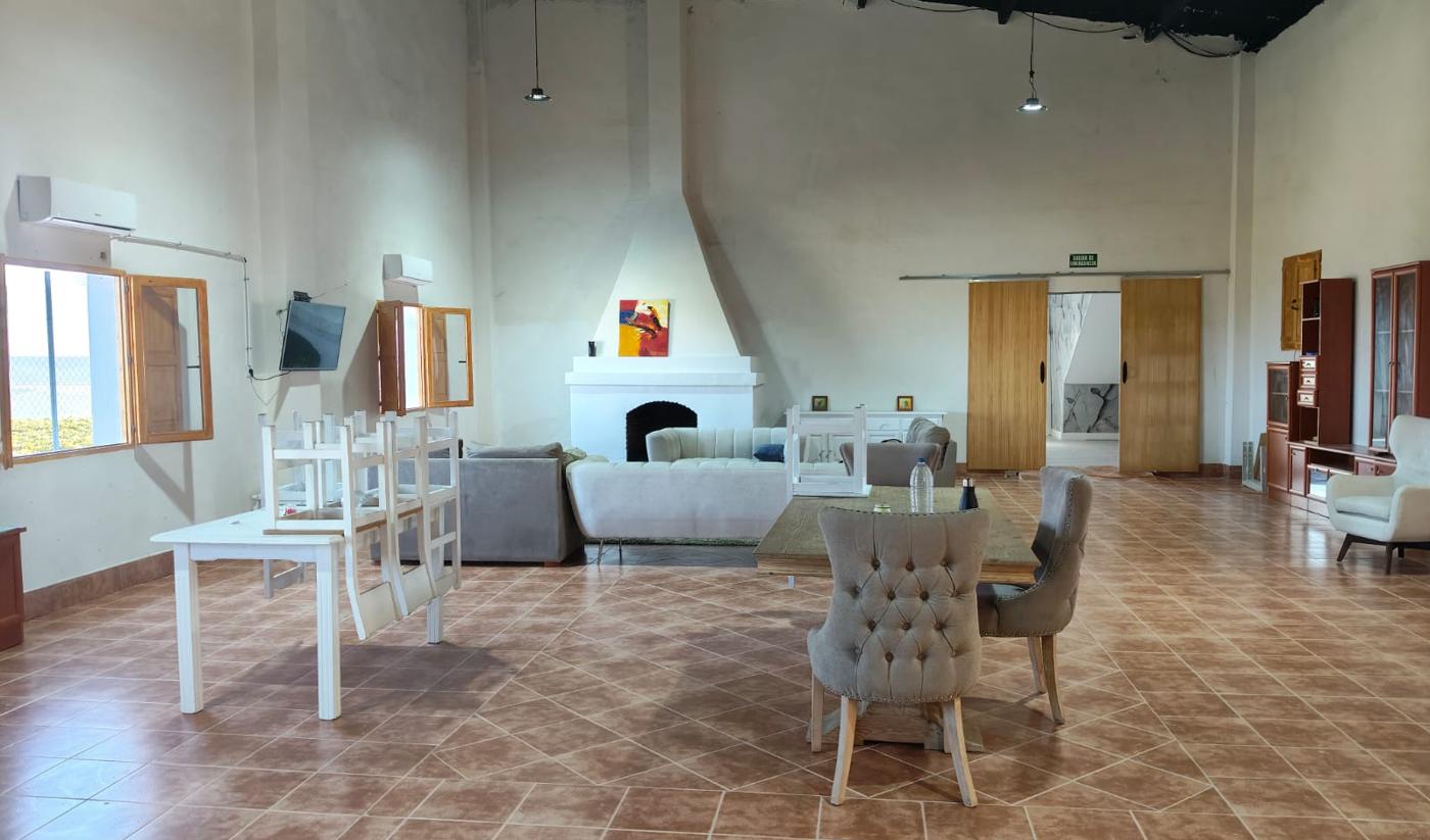 Salón común con chimenea, sofás y mesa de comedor